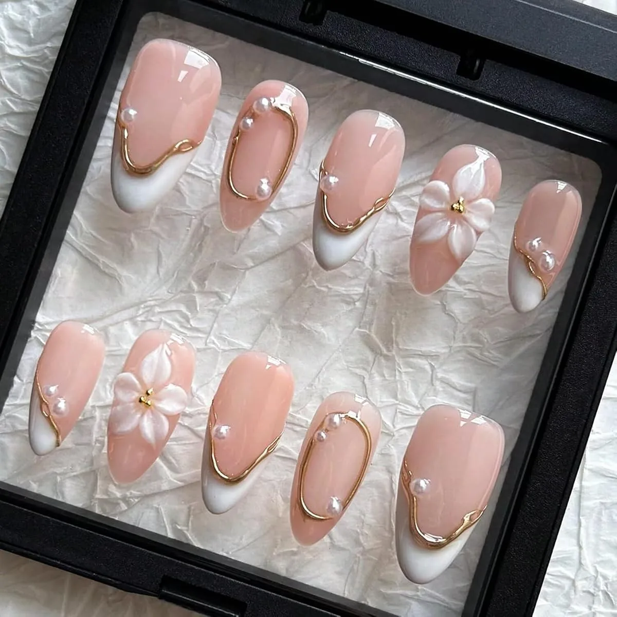 Handmade white floral press on nail tips with gold lines, pearls and white flowers in a display box