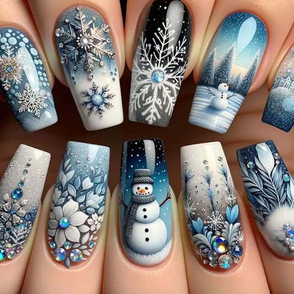 Long square winter wonderland nails in blue and white with snowflakes, rhinestones and a snowman scene