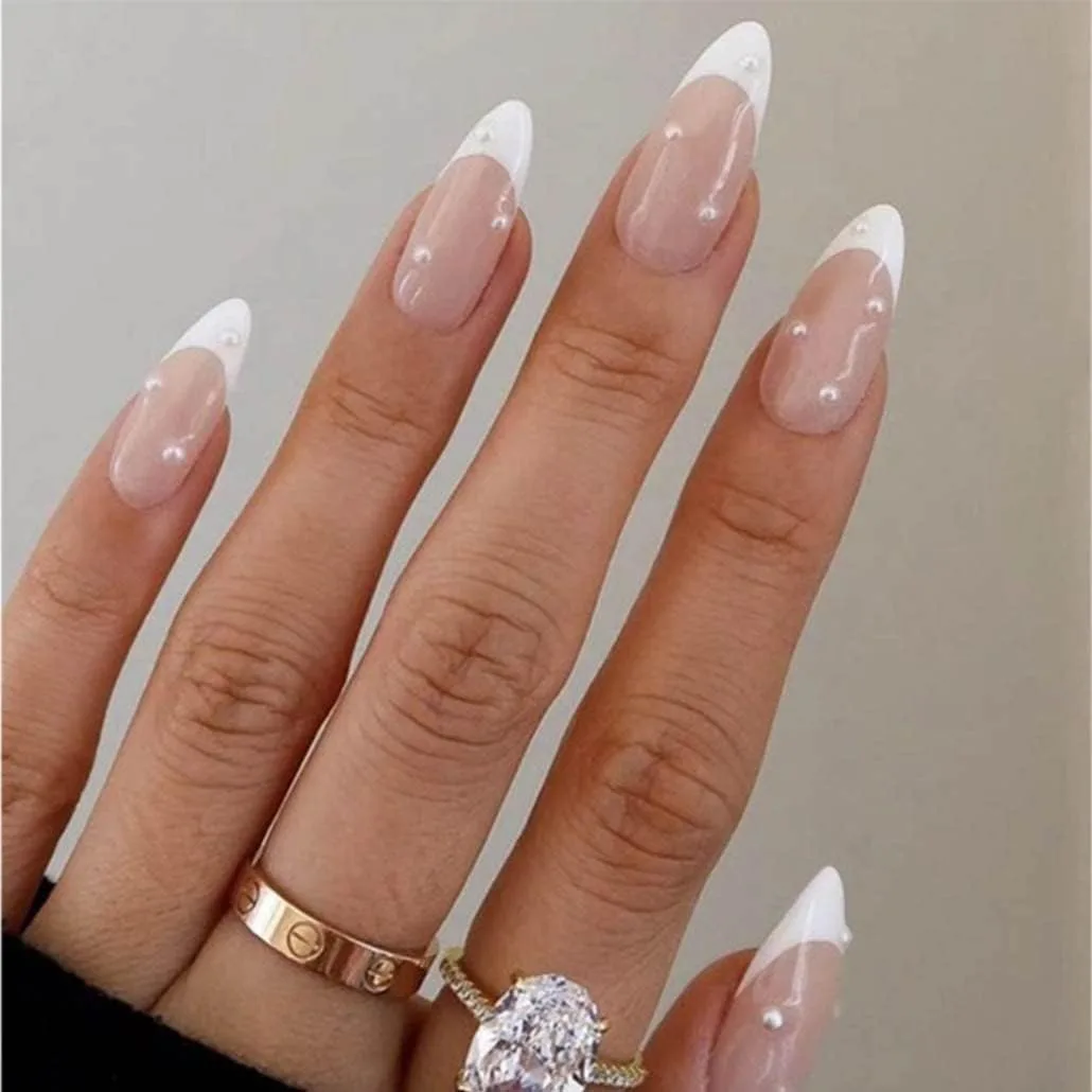 Long almond white French tip press on nails with tiny pearl dots on nude pink