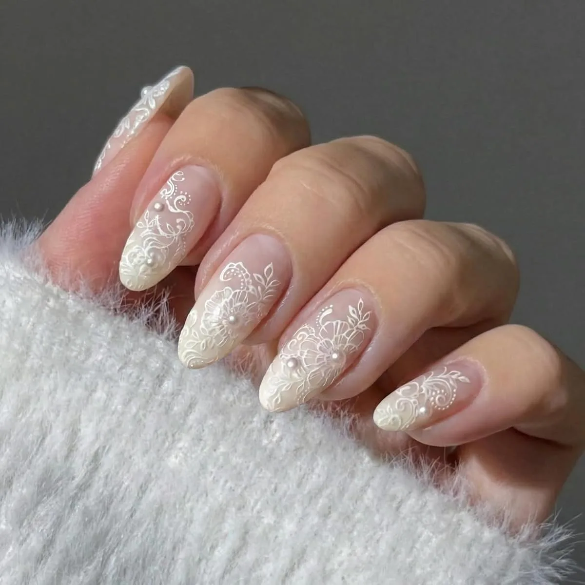 Nude pink almond press on nails with white lace floral art and pearl dots