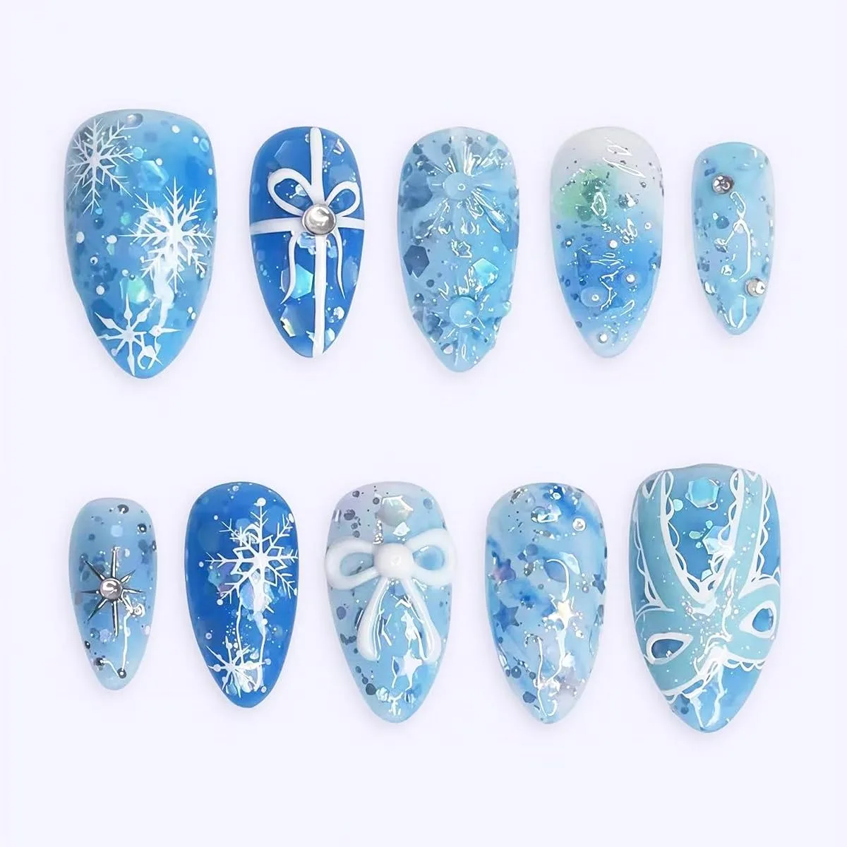 Blue winter press on nail tips with snowflakes, gift bows, glitter and rhinestones