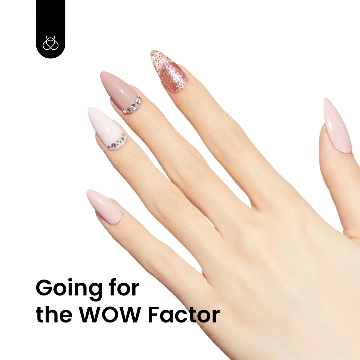 Hand with almond nails in pink and white with rhinestone cuticle accents and a rose gold glitter nail